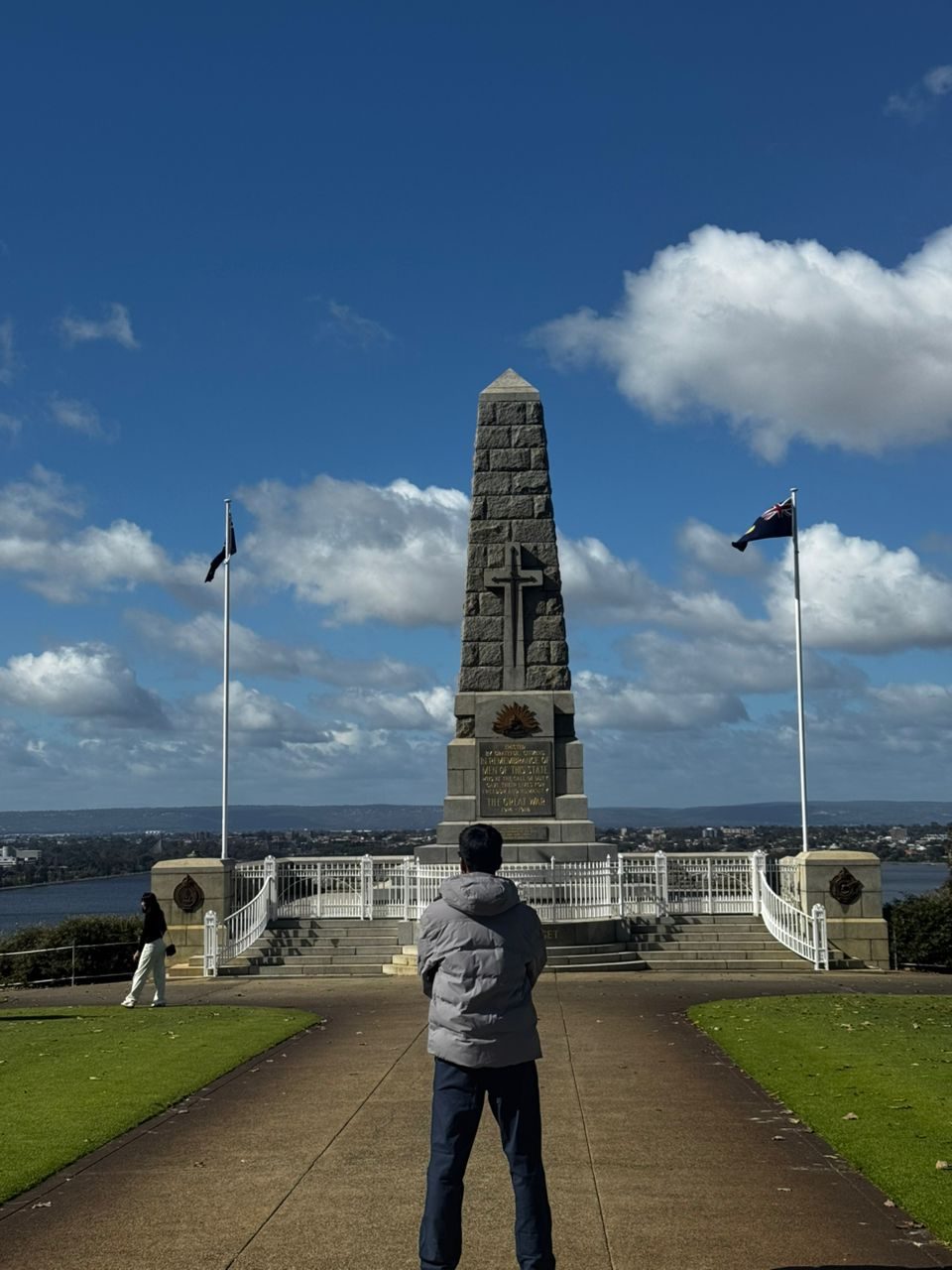 Vinesh Sinha facing a memorial obelisk