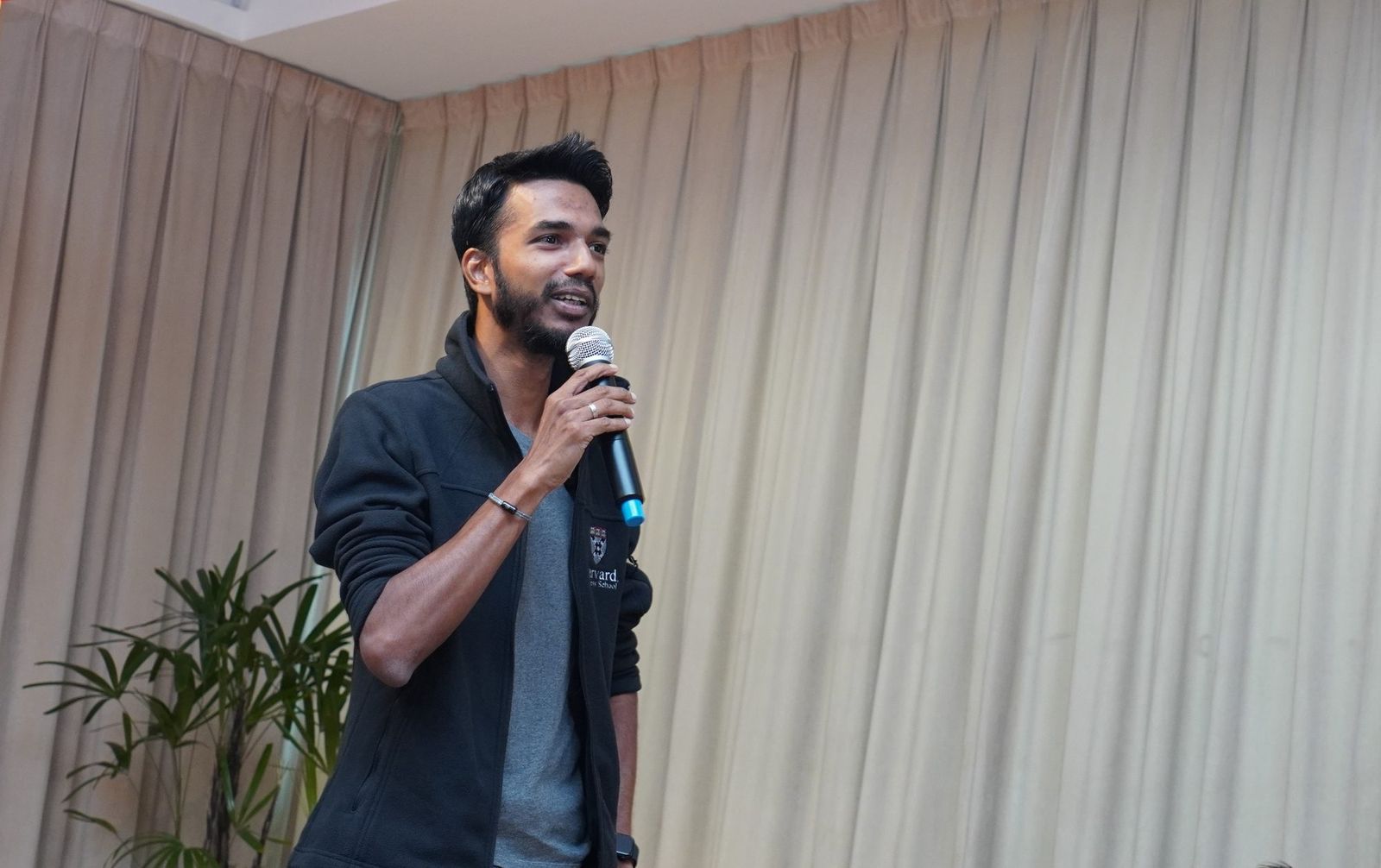 Vinesh Sinha speaking on stage